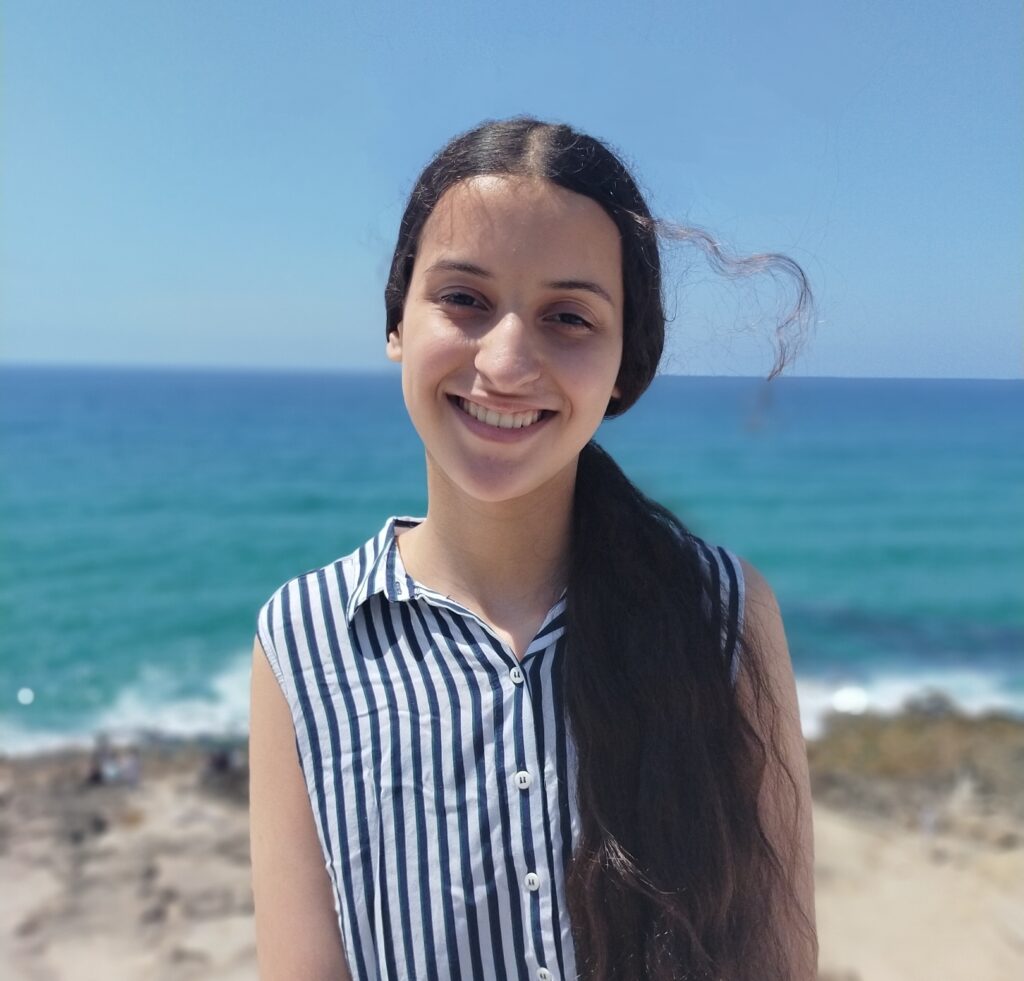 girl with the beach in the background