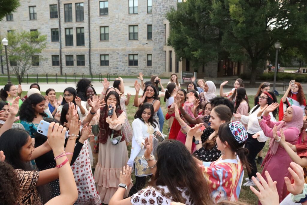 girls dressed in cultural clothing dancing together outside