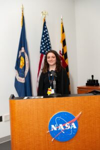 Celina smiling behind NASA podium